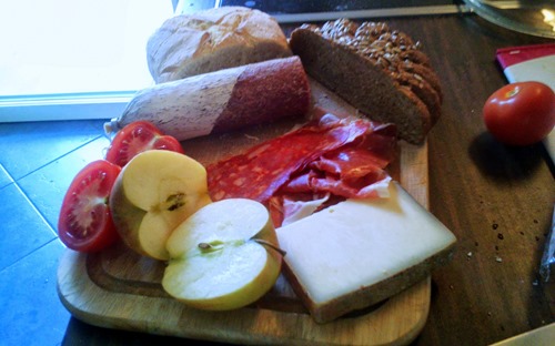 A Jausenbrettl: cured meats and cheeses, with a bread and a selection of fruit and veg on the side