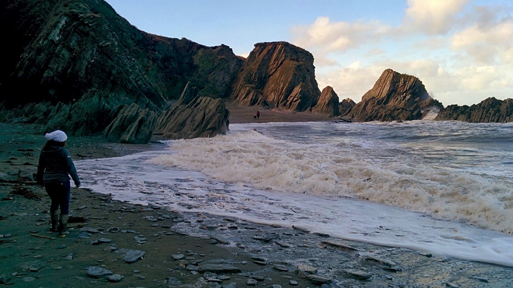 Christa dodging the Incoming tide at Lee Bay, Devon